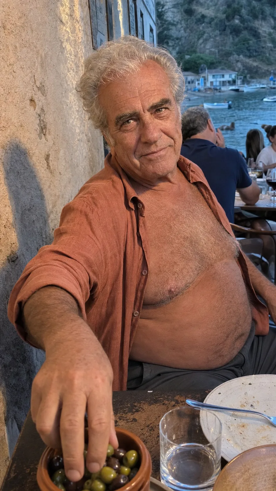 A gent reaching for olives on a Costa Brava terrace